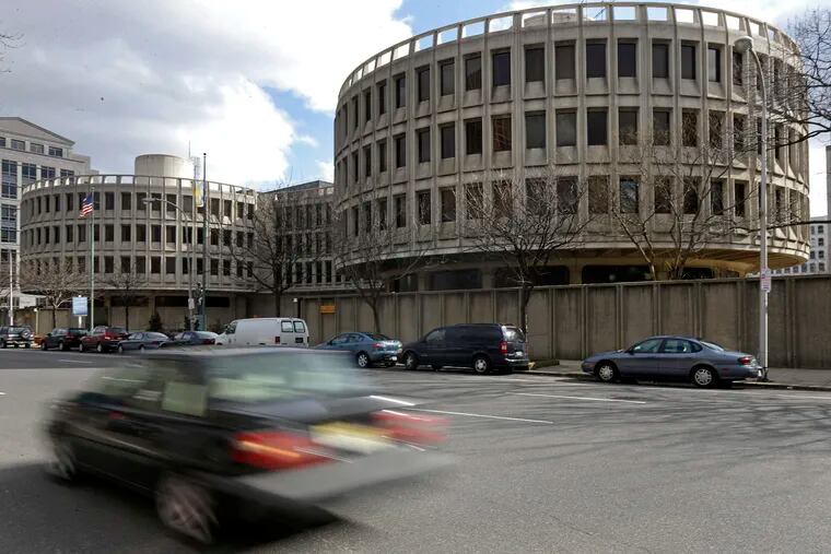 In this Feb. 27, 2013, file photo, a car drives past the Philadelphia Police Department's headquarters building, which opened in 1963 and is known as the Roundhouse, at Seventh and Race Streets.
