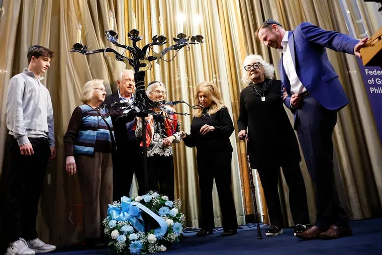 Holocaust survivors and family members light candles during the 60th Annual Holocaust Remembrance Ceremony at Temple Beth Zion-Beth Israel near Rittenhouse Square on Sunday.