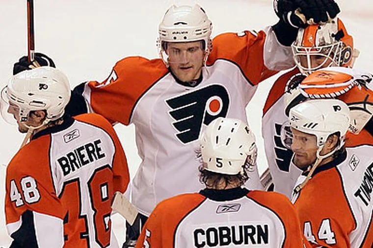 Flyers players celebrate after wrapping up their 4-0 win in Game 5. (Yong Kim/Staff Photographer)
