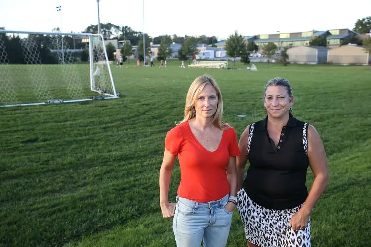Parents Jen Kuznits, left and Ginny Vitella who are Upper Dublin residents that are angry that school district and township want to take away Field of Dreams, a complex of sports fields, to use for bus garage which is behind them.