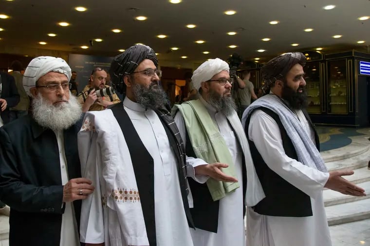 In this May 28, 2019, file photo, Mullah Abdul Ghani Baradar, the Taliban group's top political leader, second left, arrives with other members of the Taliban delegation for talks in Moscow, Russia. U.S. peace envoy Zalmay Khalilzad held on Saturday, Dec. 7, 2019 the first official talks with Afghanistan's Taliban since last September when President Donald Trump declared a near-certain peace deal with the insurgents dead.