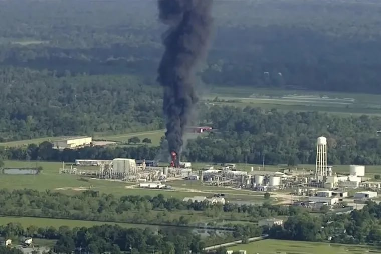 Smoke rises from a chemical plant in Crosby, near Houston, Texas. Thick black smoke and towering orange flames shot up Friday from the flooded Houston-area chemical plant after two trailers of highly unstable compounds blew up a day earlier after losing refrigeration.
