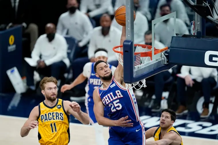 Ben Simmons (25) dunks against the Pacers' Domantas Sabonis (11) during Tuesday's game.