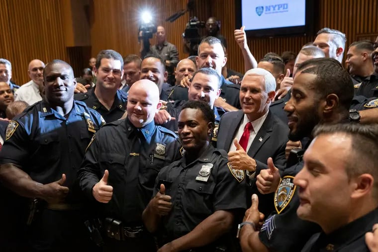 Vice President Mike Pence, second from right, meets with members of the New York Police Department's football team, Thursday, Sept. 19, 2019. Pence met earlier with the NYPD for a counterterrorism briefing. (AP Photo/Mark Lennihan)