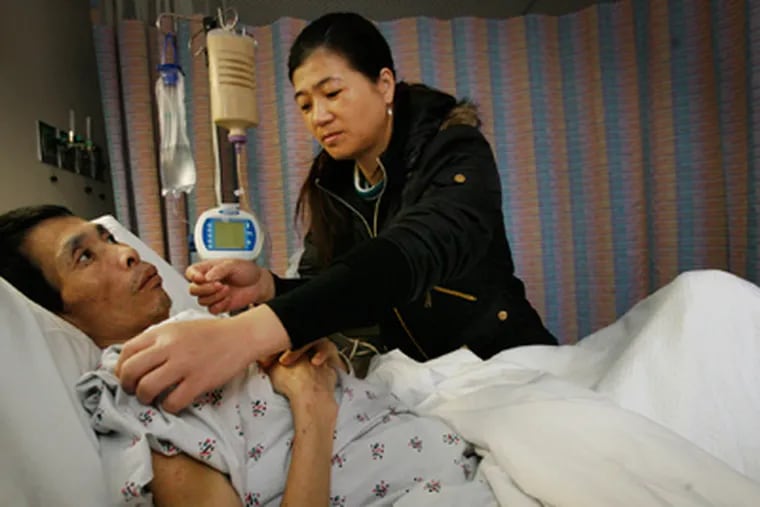 Jicun Wu, with wife Qinhui Chen, was assaulted in June. (Alejandro A. Alvarez / Staff Photographer)