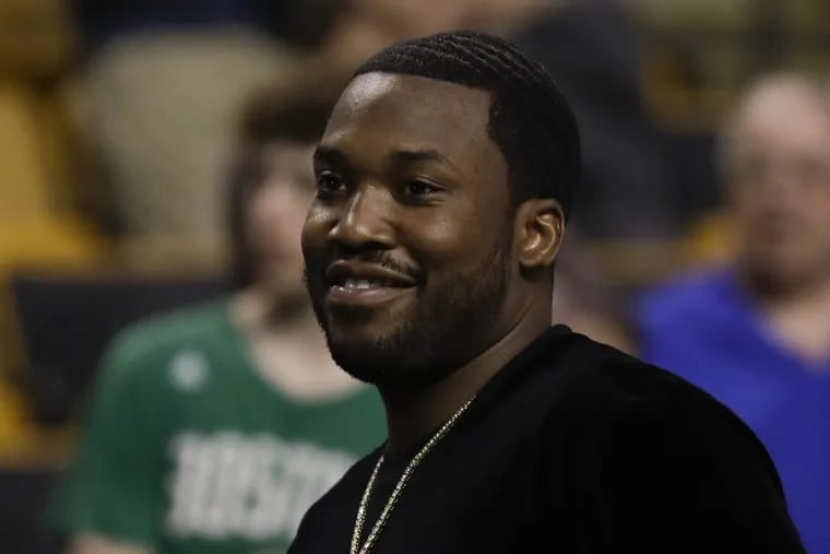 Rapper Meek Mill smiles before the Sixers play the Boston Celtics in game two of the Eastern Conference semifinals on Thursday, May 3, 2018 in Boston.