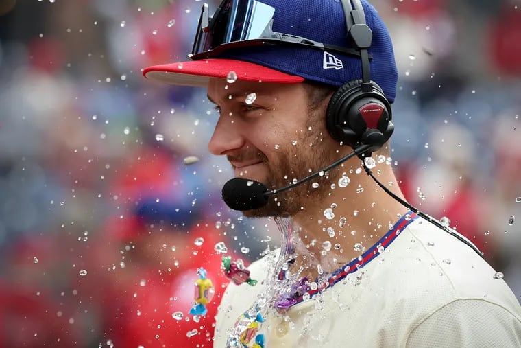 Philadelphia Phillies shortstop Trea Turner takes a face full of water, seeds and gum as he is interviewed after the game.