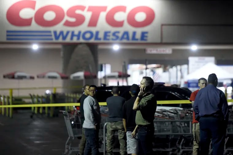 A Costco employee talks on the phone following a shooting within the wholesale outlet in Corona, Calif.,  Friday, June 14, 2019.  A gunman opened fire inside the store during an argument,  killing a man, wounding two other people and sparking a stampede of terrified shoppers before he was taken into custody, police said. The man involved in the argument was killed and two other people were wounded, Corona police Lt. Jeff Edwards said.  (Will Lester/Inland Valley Daily Bulletin/SCNG via AP)
