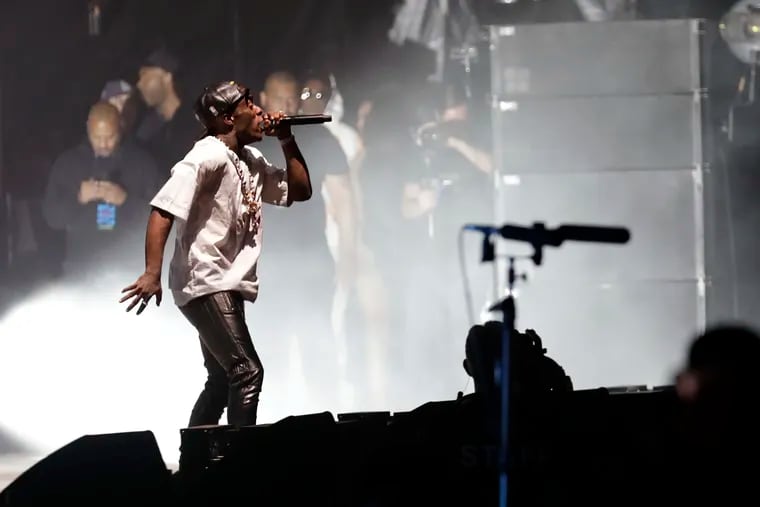Jay-Z (in background wearing sunglasses) watches Lil Uzi Vert perform during the second day of last year's Made in America Festival on the Benjamin Franklin Parkway, Sept. 1, 2019.