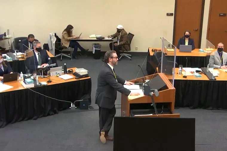 In this screen grab from video, defense attorney Eric Nelson (center) listens as Hennepin County Judge Peter Cahill presides over jury selection in the trial of former Minneapolis police officer Derek Chauvin.