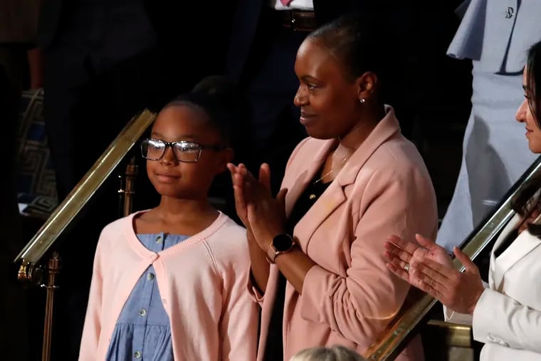 Janiyah, left, and Stephanie Davis of Philadelphia, listen as President Donald Trump delivers his State of the Union address to a joint session of Congress on Capitol Hill in Washington, Tuesday, Feb. 4, 2020.