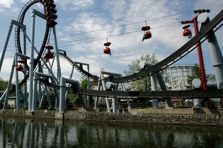 In this file photo, the Great Bear, an inverted roller coaster, and the Skyview ride are seen at Hersheypark in Hershey, Pa.