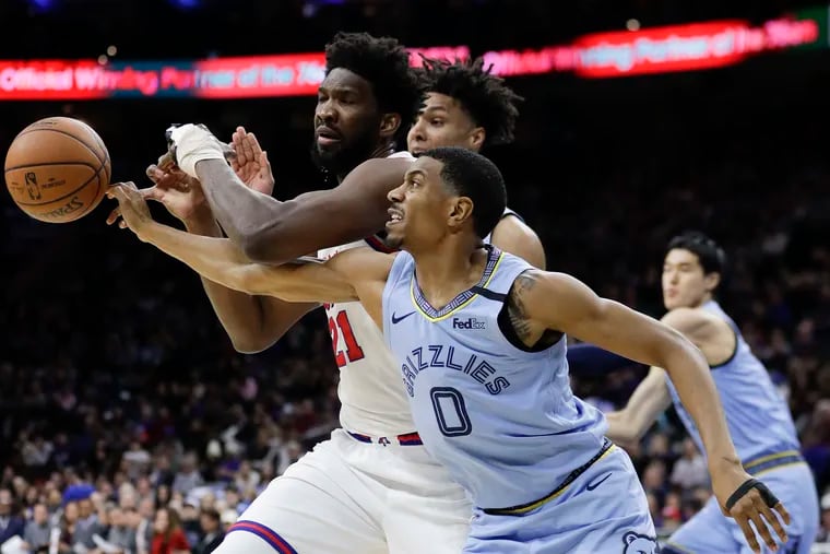 Sixers center Joel Embiid getting the basketball knocked away from Memphis Grizzlies guard De'Anthony Melton during the first quarter on Feb. 7, 2020 in Philadelphia.