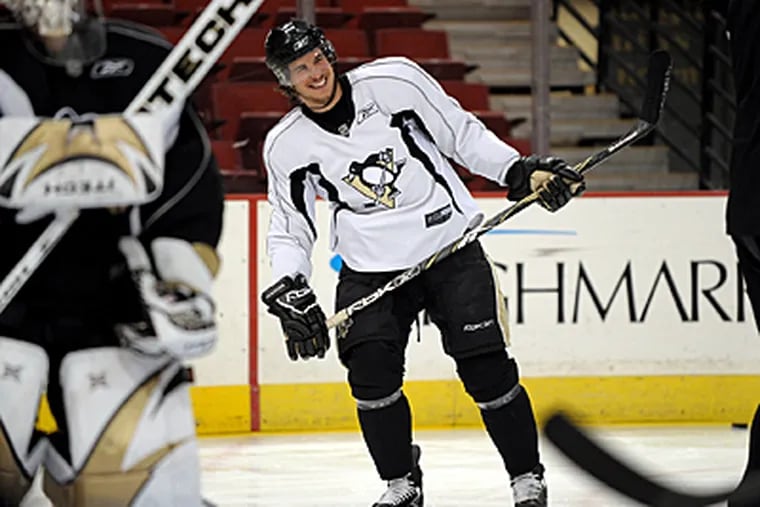 Pittsburgh Penguins' Sidney Crosby smiles after scoring a goal during practice in Pittsburgh Friday. The Penguins face the Detroit Red Wings in the Stanley Cup finals first game on Saturday. (AP)