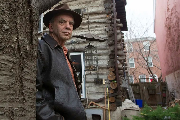 Jeff Thomas in the backyard of his log cabin home in Northern Liberties, He built it in 1985 after returning to the city, where he had been an art student. It sits on four lots of the gentrifying neighborhood.