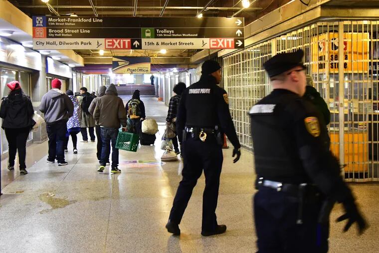 SEPTA Transit Police move through the concourse outside Suburban Station on Tuesday, after clearing out the large number of homeless people who routinely stay there.