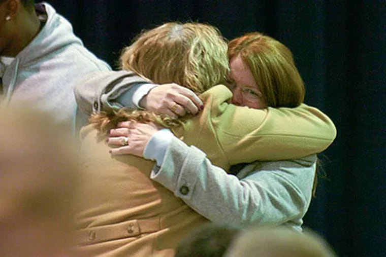 Peggy Keeley, mother of PGW worker Mark Keeley who was killed in the Tacony gas line explosion earlier this week, is hugged by a well-wisher during a memorial service at St. Cecelia's Parish auditorium Thursday. (Ron Tarver / Staff Photographer)