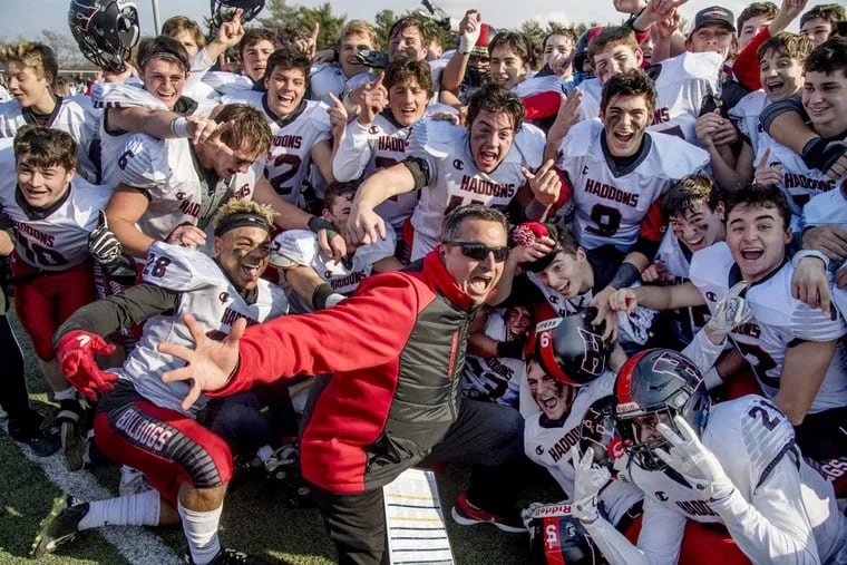 Haddonfield High School football coach Frank DeLano celebrates the SJ2 championship with his players after they beat West Deptford 21-17 December 3, 2017 at Rowan University.