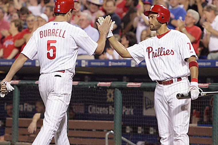 Pedro Feliz congratulated Pat Burrell after Burrell's two-run home run broke a 1-1 tie in the sixth inning. (Jerry Lodriguss/Inquirer)
