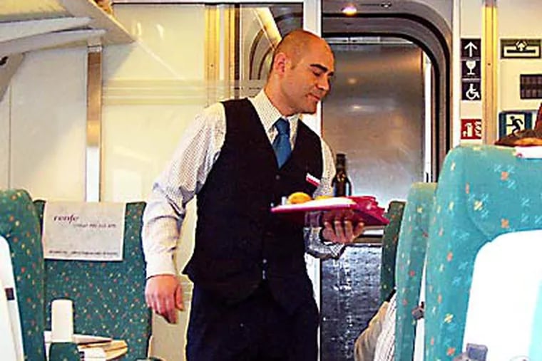 RAIL - Photo by Paul Nussbaum - An attendant serving snacks and drinks on a high-speed Spanish train between Madrid and Valladolid. With smooth rides, no long waits in security lines, and fast trips, high-speed trains have replaced airplanes as the most-popular mode of travel on many routes in Europe.