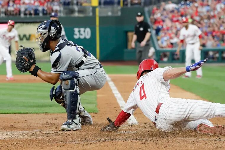 Phillies Scott Kingery scores on a base hit by teammate Zach Eflin past San Diego Padres catcher Francisco Mejia during the second-inning on Saturday, August 17, 2019 in Philadelphia.