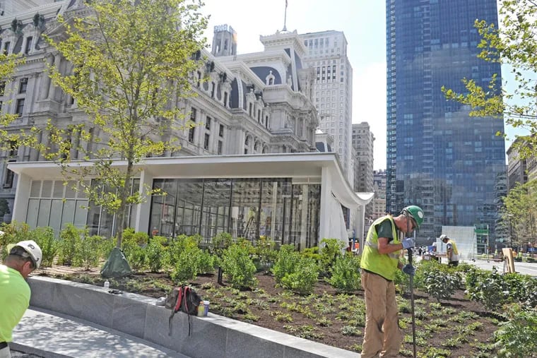 Workers put finishing landscape touches in front of the new cafe at Dilworth Park in front of City Hall (Northwest Side) Aug. 19, 2014.  The cafe will be called Rosa Blanca and will be operated by the famed Philadelphia chef Jose Garces.  The park will partially open (about 2/3's) on Sept. 4, 2014.  The concourse will be completely open by that date.  ( CLEM MURRAY / Staff Photographer )