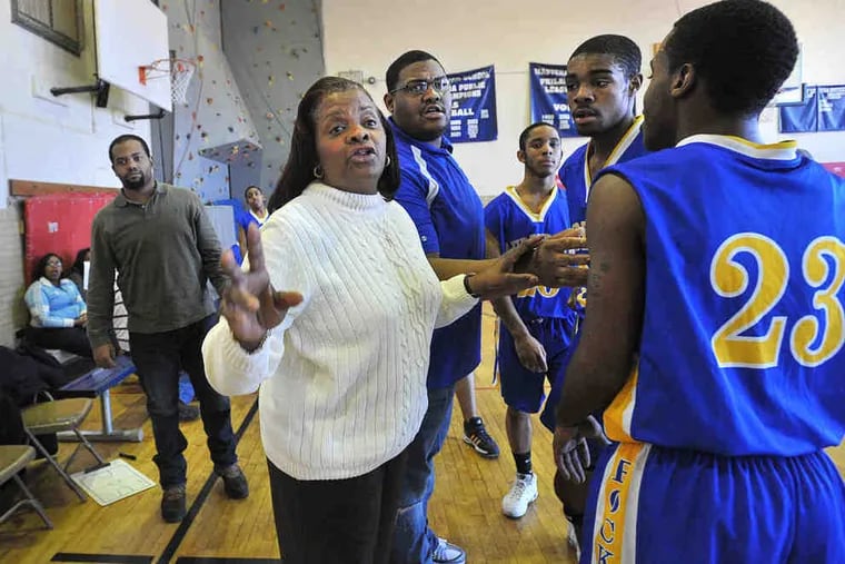 Tina Wiggins guided her team to a 14-3 overall record in the regular season, the best mark in school history. Behind her (center) is Wali Smith, one of her three assistant coaches.