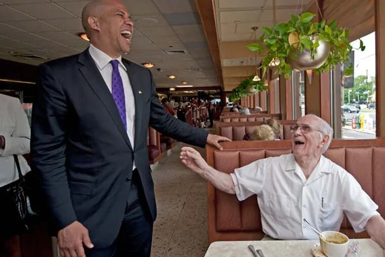 Newark Mayor Cory Booker campaigns in South Jersey, at a town hall meeting at the South Jersey Technology Park in Mullica Hill and Ponzio's Diner in Cherry Hill on July 10, 2013.   Here, at Ponzio's, he laughs with diner Joe Capitanio of Mount Holly, NJ. ( APRIL SAUL / Staff )