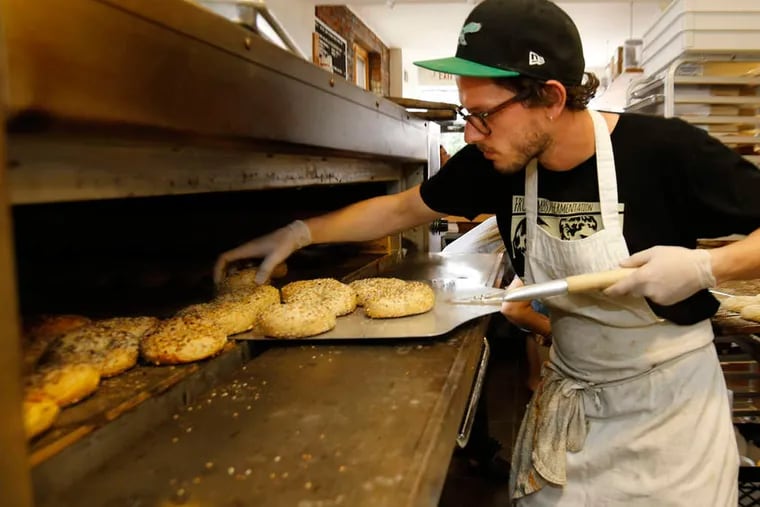 Philly Style Bagels' Jonathon Zilber is constantly rotating the bagels through the oven, so they bake evenly.   ( Michael Bryant / Staff Photographer )