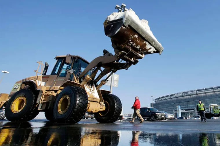 Workers remove snow at MetLife Stadium in East Rutherford, N.J., which will host the Super Bowl Feb. 2 - barring horrible weather.