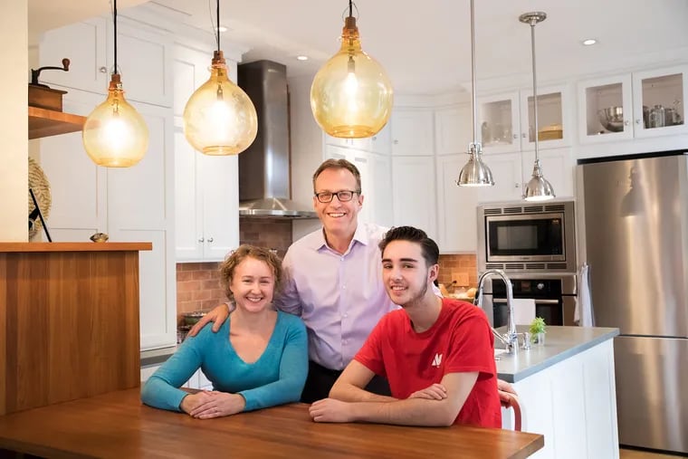 Heidi Siegel, Frank Van Lint, and Siegel's son, Dante Ingargiola, in their remodeled kitchen, which includes sustainable materials such concrete countertops.