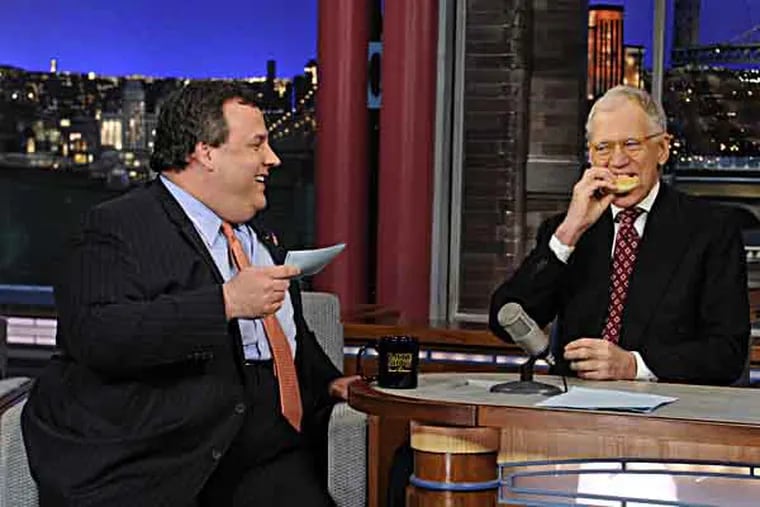 In this photo released by CBS Broadcasting, New Jersey Gov. Chris Christie, left, chats with David Letterman, right, during his first visit to CBS’ “Late Show with David Letterman,” on Monday, Feb. 4, 2013 in New York.  (AP Photo/CBS Broadcasting, Jeffrey Neira)