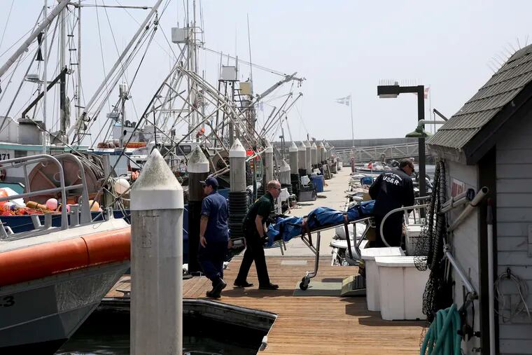 On the dock at Santa Barbara Harbor in California, search and rescue and sheriff's officers move a body recovered near a dive boat fire near Santa Cruz Island early Monday, Sept. 2.
