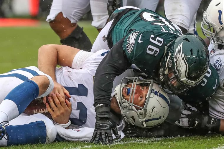 Indianapolis quarterback Andrew Luck is sacked by Eagles Derek Barnett  in the second quarter of their game on Sunday , September 23, 2018.