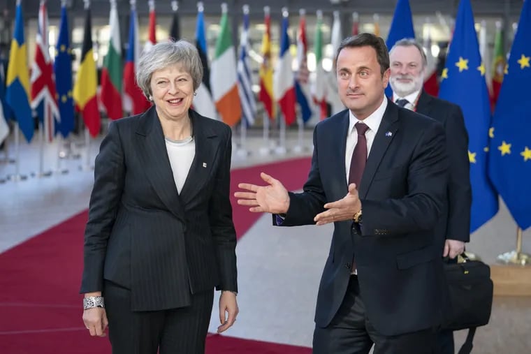 Theresa May, U.K. prime minster, is welcomed by Xavier Bettel, Luxembourg's prime minister, as Tim Barrow, U.K. permanent representative to the European Union looks on at a European Union leaders summit in Brussels on Dec. 13, 2018. (Jasper Juinen / Bloomberg)