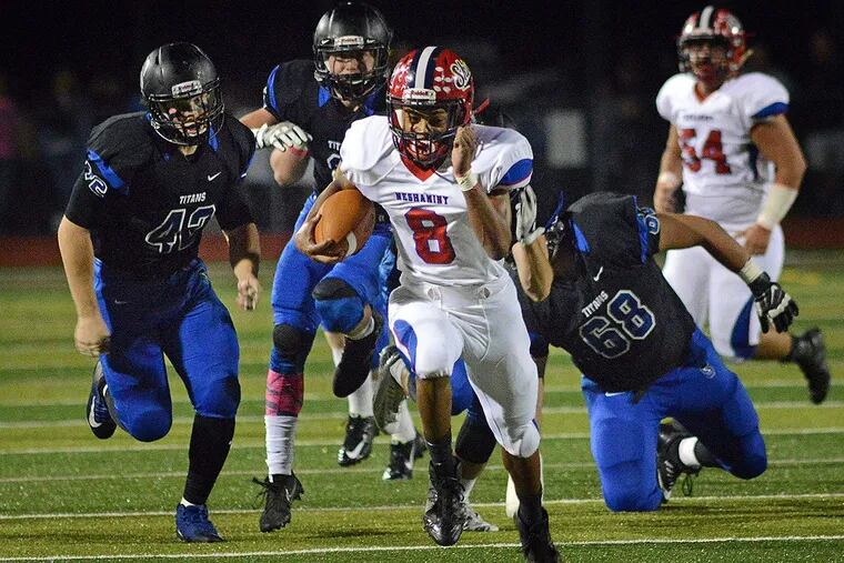 Neshaminy’s Savion Hebron (8) breaks free of Central Bucks South defenders on his way to scoring a touchdown.