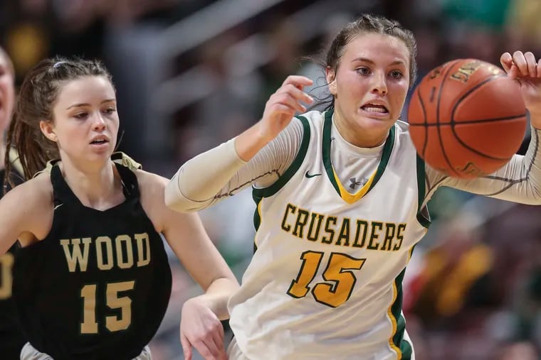 Archbishop Wood Allie Fleming and Lansdale Catholic Gabby Casey chase a loose ball during the 4th quarter of the PIAA 4a District XII Championship at the The Giant Center in Hershey, Thursday, March 24, 2022.  Wood beats Lansdale Catholic 57-45 for the State Championship.
