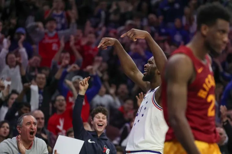 Sixers center Joel Embiid celebrates with the fans after making a basket and drawing the foul in the fourth quarter against the Pacers on Sunday.
