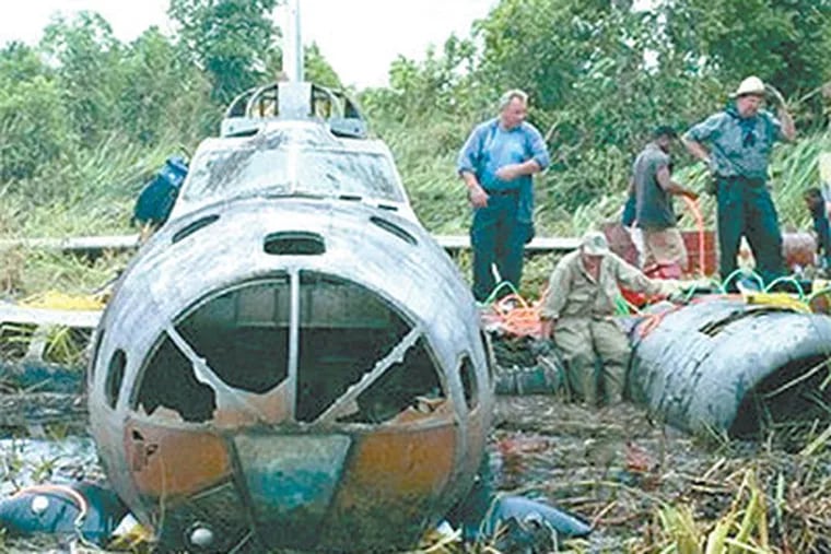 A salvage team prepares to remove a B-17 bomber from a Papua New Guinea swamp, where it has rested since 1942. (Michael Murray / Adrenaline Films)
