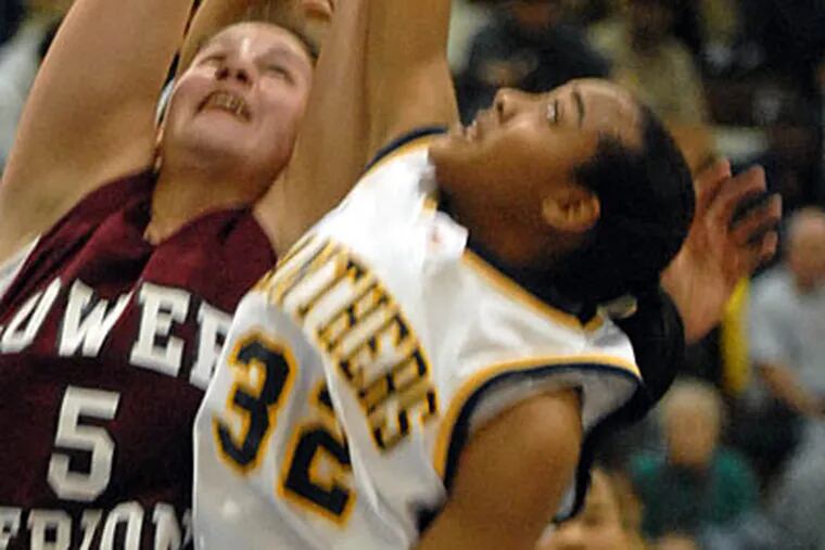 Cheltenham's Shayla Felder (right) and Lower Merion's Amy Wood (left) goes up for a rebound in 2nd period action. (Ron Tarver / Staff Photographer)