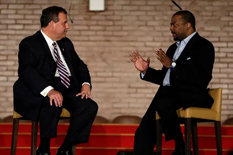 New Jersey Gov. Chris Christie, left, talks with New Hope Baptist Church pastor Joe Carter during a summit talking about drug addiction, on Tuesday, Sept. 30, 2014, in Newark, N.J. (AP Photo/Julio Cortez)
