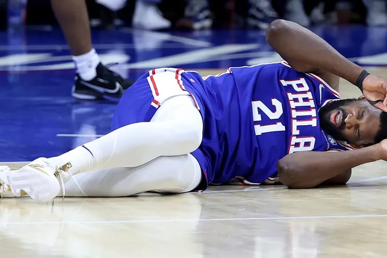 The Philadelphia 76ers' Joel Embiid on the court after a hard foul by the Miami Heat's Bam Adebayo during the second half of Game 3 in the second-round Eastern Conference playoff series at the Wells Fargo Center on May 6, 2022, in Philadelphia. (Charles Fox/The Philadelphia Inquirer/TNS)