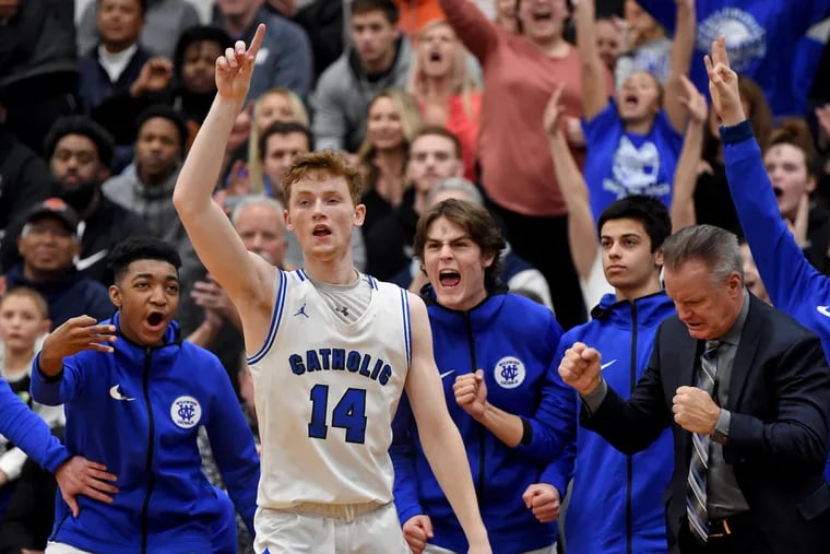 Wildwood Catholic's Jacob Hopping reacts as he sinks a three-pointer in front of his bench and coach Dave DeWeese (right) in the fourth quarter.