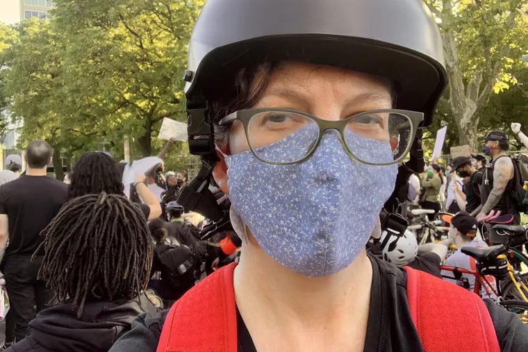 Inquirer reporter Kristen Graham was arrested June 1 after covering protests in Center City. She was handcuffed and taken into custody for being out past curfew despite having an essential employee exemption, displaying her press pass prominently and telling officers she was a reporter.