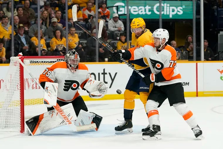 Flyers goaltender Carter Hart (79) and Tony DeAngelo (77) were busy Saturday night against the Predators but came away with the win.