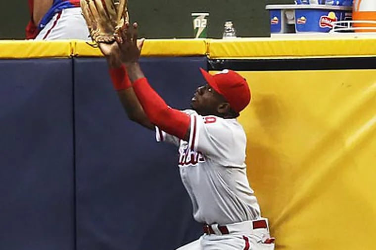 Domonic Brown could not catch Corey Hart's grand slam in the bottom of the eighth inning on Thursday. (Tom Lynn/AP)