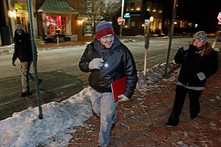 David Weathingto, center, uses his flashligh to look down a dark alley in downtown West Chester as he and his team, Alvin Herring, left, and Andrea Roberts, right, look for homeless people in Chester County on Wednesday Jan. 29, 2014. ( MICHAEL BRYANT / Staff Photographer )