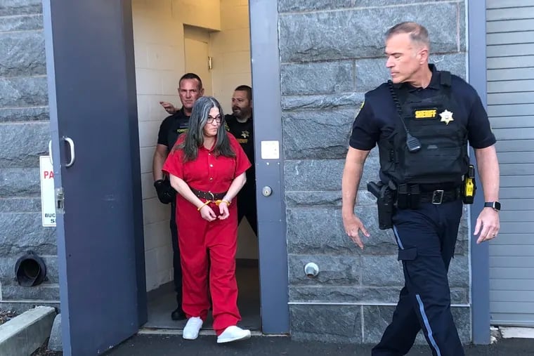 Ana Maria Tolomello is escorted out of the Bucks County Courthouse after pleading guilty Monday to third-degree murder.