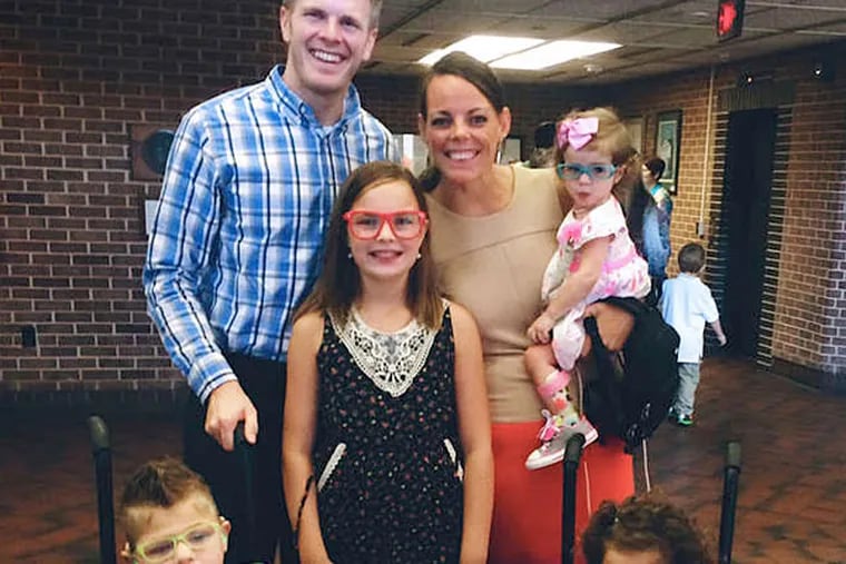 Adam and Karen Owens (rear) with their family: Madison and Harper (middle row), Jayden and Angela (front). The loss of a child helped the couple open their hearts. (Family photo)