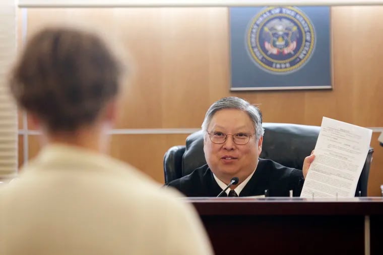 FILE - In this May 25, 2010, file photo, Judge Michael Kwan talks with a defendant during drug court in Taylorsville, Utah. Kwan, a longtime Utah judge, has been suspended without pay for six months for comments he made online and in court criticizing President Donald Trump that the state's supreme court determined violated the judicial code of conduct. (Jeffrey D. Allred / The Deseret News via AP, File)